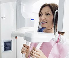 woman in x-ray machine biting down