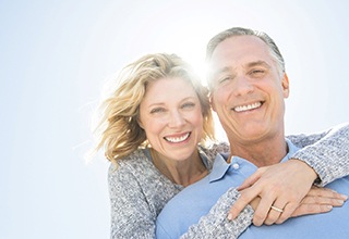 Mature couple smiling with dentures in Owasso