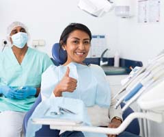 Woman giving thumbs up to her Owasso emergency dentist