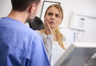 Emergency dentist in Owasso speaking with a patient