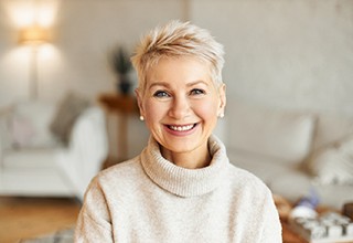 Smiling woman with dental implants in Owasso