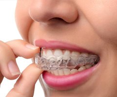 Woman using Invisalign clear aligner