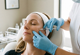 Man receiving dermal filler injection in his jaw