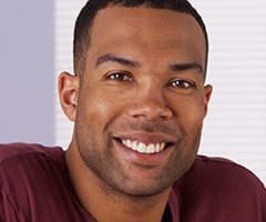 man in maroon shirt smiling