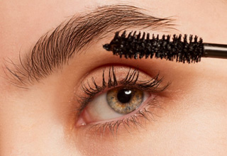 a woman applying Latisse to her eyelashes