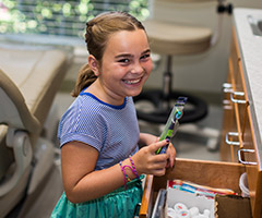 young girl smiling with toothbrush