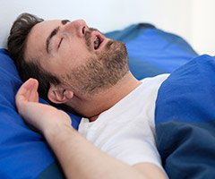 man snoring with mouth open