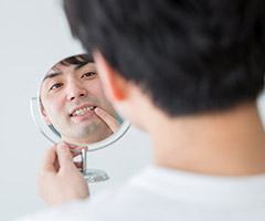 man looking at smile in circle mirror