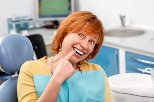 older woman smiling in dental chair