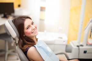 A woman smiling at her dental visit.