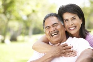 Smiling couple in summer with dental implants in Owasso